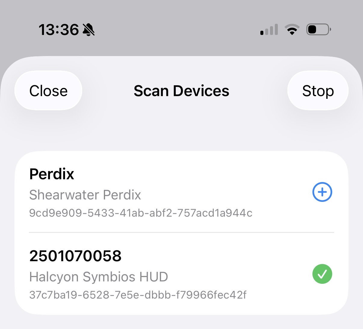 Scan results with an already-added device showing a green checkmark